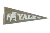 Circa 1940s vintage Yale felt pennant featuring white bulldog, Yale text, football on taupe. 11x28.