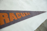 Vintage Syracuse pennant detail, showing creased orange lettering on dark blue felt.
