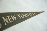 Light cream 'NEW YORK CITY' lettering on dark felt vintage pennant.