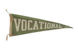 Vintage Vocational School felt pennant in aged green with off-white block lettering.