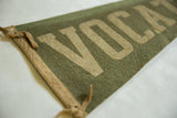 Angled view of the vintage vocational pennant showing its felt texture and tan ties.