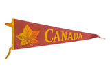 Vintage Canada felt pennant, reddish-brown with yellow Maple Leaf graphic and text, 9x27 inches.