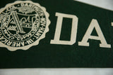 Close-up of green felt texture and cream 'DA' lettering on vintage Dartmouth pennant.