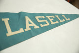 Cream 'SELL' letters on teal felt vintage Lasell pennant, with visible light creasing.