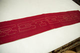 Textured red vintage felt banner with white outlined 'EXET' letters.