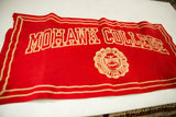Vintage Mohawk College banner in red felt, angled to show the wavy texture and lettering.