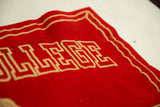 Close-up of the vintage banner's red felt texture and beige geometric lettering.
