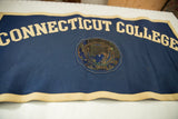 Dark blue vintage Connecticut College felt banner with cream letters and a damaged central seal.