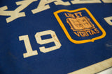 Vintage Yale felt banner detail, featuring cream '19' numerals with subtle patina and the university shield.