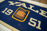 Vintage Yale 1951 felt banner detail, showing cream '51' and 'VERITAS' on shield.