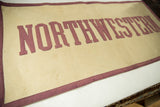 Vintage Northwestern felt banner with aged beige and deep maroon lettering, 18x34 inches.