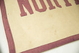 Vintage felt banner, close-up of stitched maroon border on cream felt with subtle patina.