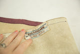 Collegiate label on vintage Northwestern felt banner, showing wool-cotton blend and creasing.