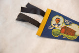 Vintage blue felt pennant with Abraham Lincoln portrait, log cabin graphic, yellow trim.