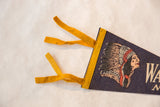 Corner detail of the vintage felt pennant showing yellow ties and Native American graphic.