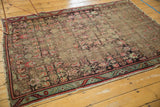Antique Karabagh rug displays cherry red serrated border, Herati motif, and visible foundation.
