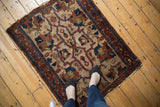 Antique Lilihan rug with ivory field, thick vinery, oversized palmettes, and visible tatter.