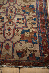 Antique Lilihan rug detail: finely drawn border with indigo vine, botehs, and tattered fringe.