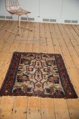 Aged fringe and indigo, chestnut patterned border of an antique Persian Lilihan rug.