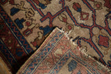Antique Lilihan rug corner with distressed ivory pile, exposed foundation, and tattered fringe.