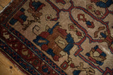 Antique Lilihan rug corner detail, deep red border, blue patterns, and visible wear.