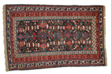 Antique Caucasian Kuba rug, geometric plant and serpent motifs, charcoal, raspberry, blue, ivory, time-softened.