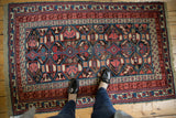 Antique Caucasian Kuba rug, geometric plant and serpent motifs, raspberry, sky blue, charcoal.