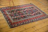 Antique Caucasian Kuba rug corner: raspberry red, sky blue geometric borders with etching.