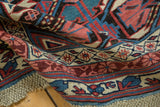 Original macramé ends of the antique Kuba rug with sky blue and raspberry geometric border.