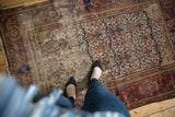 Antique Malayer rug, allover floral field in madder red and ivory, showing heavy wear.