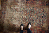 Antique Malayer rug detail, allover floral field showing hard wear to foundation, rust and indigo.