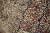 Hard wear revealing foundation on antique Malayer rug with madder red and indigo floral design.