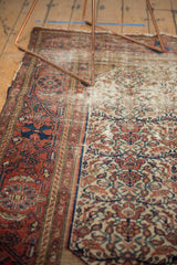 Ivory field of the antique Malayer rug featuring madder root red rust blossomed florals and indigo vines.