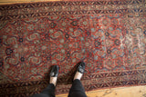 The intricate Herati pattern and character-rich wear of an antique Persian Malayer runner.