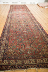 A long perspective view of an antique Malayer runner displaying its rhythmic Herati pattern.