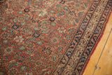 Wear to knot heads on the red and navy Herati patterned field of an antique Malayer runner.