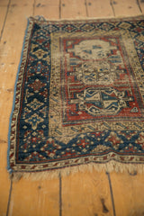 Antique Beshir rug end with secured fringe and geometric navy, madder red border.