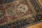 Beshir rug's geometric gul, banded border, navy, madder root red, beige, with mostly even wear.