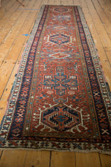 Geometric patterns of a Karaja runner in madder red, ivory, and navy blue border.