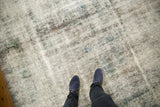 Heavily distressed vintage Sarouk carpet with worn texture, visible foundation, muted colors.