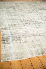 Distressed vintage Sarouk carpet texture highlighting visible foundation, charcoal, and ivory tones.