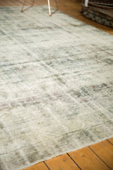 Vintage distressed Sarouk carpet texture, revealing knot heads and etched foundation in charcoal, purple, ivory.