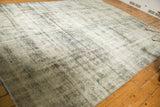Distressed Sarouk carpet's surface showing even wear, knot heads, and exposed foundation.