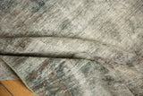 Etched foundation and knot heads on a distressed Sarouk carpet in charcoal, purple, ivory.