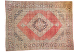 Distressed vintage Persian Jalili Tabriz carpet with blush red field and central medallion design.