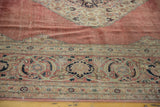 Worn texture of blush red field, intricate corner spandrel, and navy blue Tabriz border.