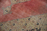 Distressed blush red field with a patterned sand and blue decorative border.