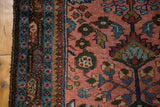 Edge detail of vintage Lilihan runner showing sky blue border and rasberry red field, interconnected florals.