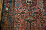 Hand knotted vintage Lilihan rug with raspberry floral design, sky blue border, and low pile.