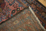 Hand-knotted Lilihan rug showing its foundation, secured edge, and raspberry floral pile.